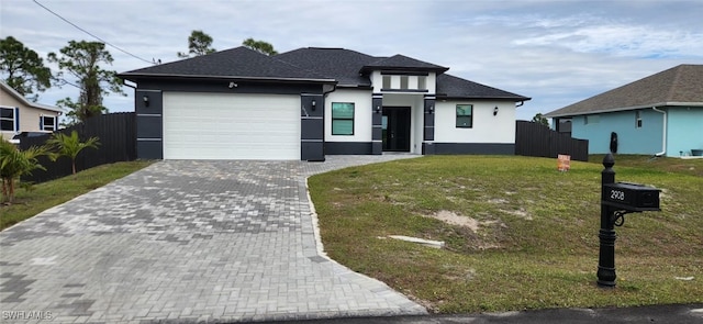 view of front of house featuring a front yard and a garage