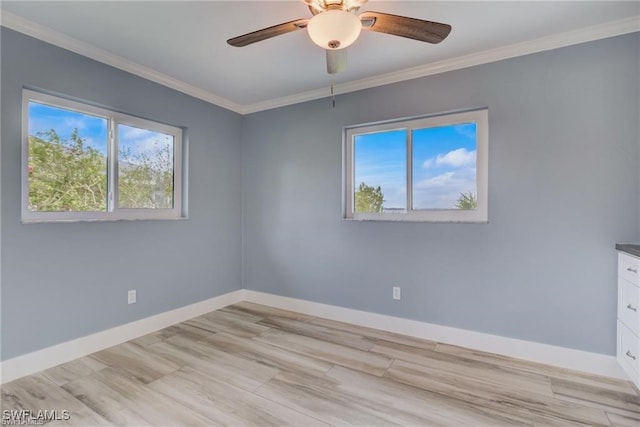 spare room with ornamental molding, light hardwood / wood-style floors, and ceiling fan