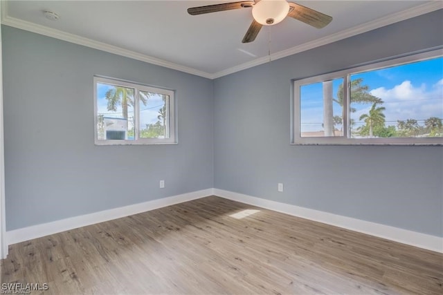 empty room featuring crown molding, ceiling fan, and light wood-type flooring