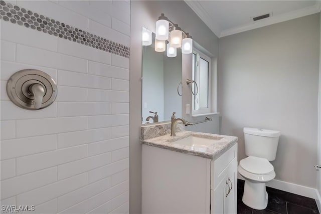 bathroom with vanity, ornamental molding, and toilet