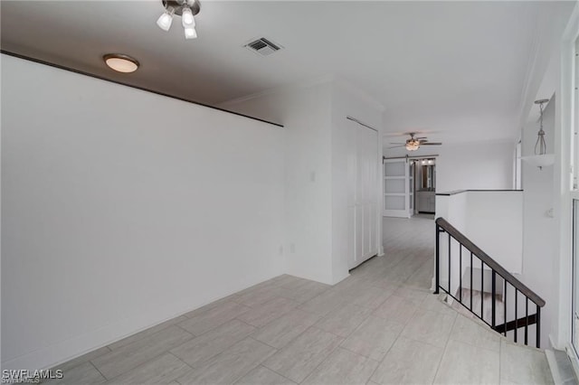 interior space featuring ornamental molding and ceiling fan