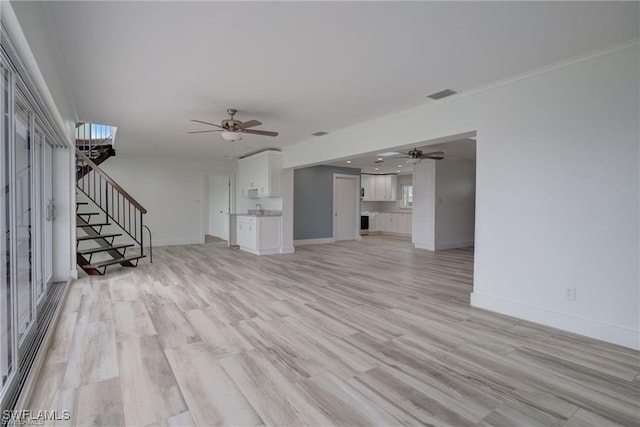 unfurnished living room featuring light hardwood / wood-style floors and ceiling fan