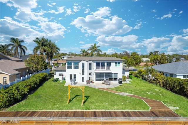 rear view of house with a patio and a yard