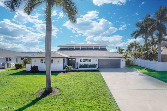 view of front property with a garage and a front lawn