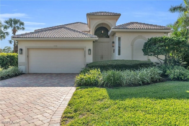 mediterranean / spanish-style house with a front yard and a garage