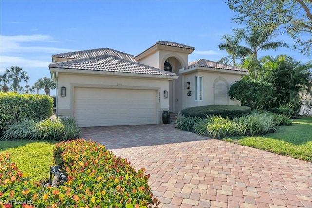 mediterranean / spanish house with a garage