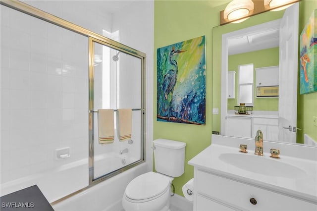 full bathroom featuring toilet, vanity, and shower / bath combination with glass door