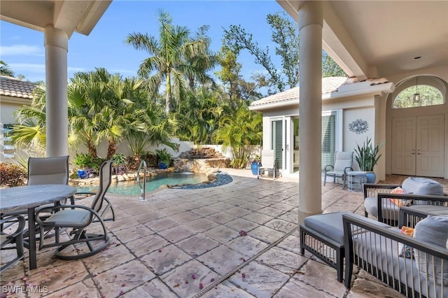 view of patio with pool water feature and a fenced in pool