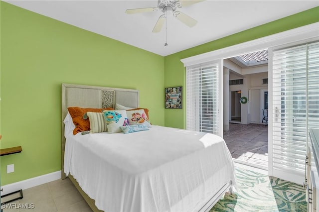 tiled bedroom featuring ceiling fan and multiple windows