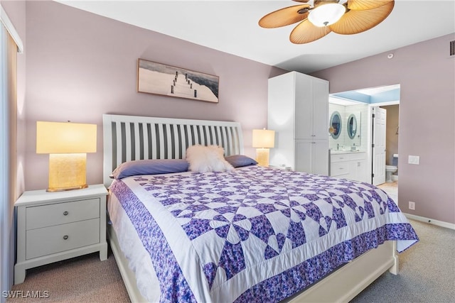 bedroom with ceiling fan, light colored carpet, and connected bathroom