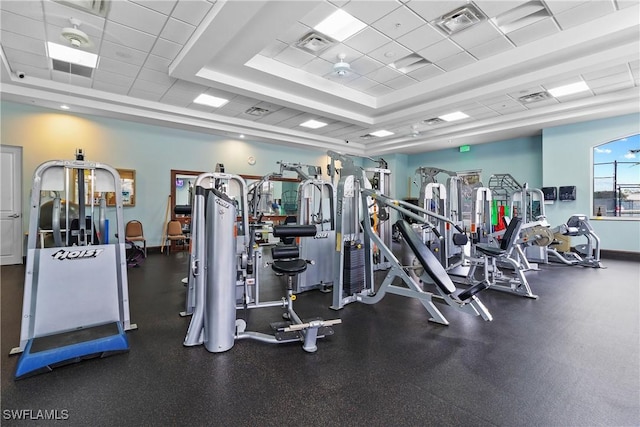 gym with a drop ceiling and a tray ceiling