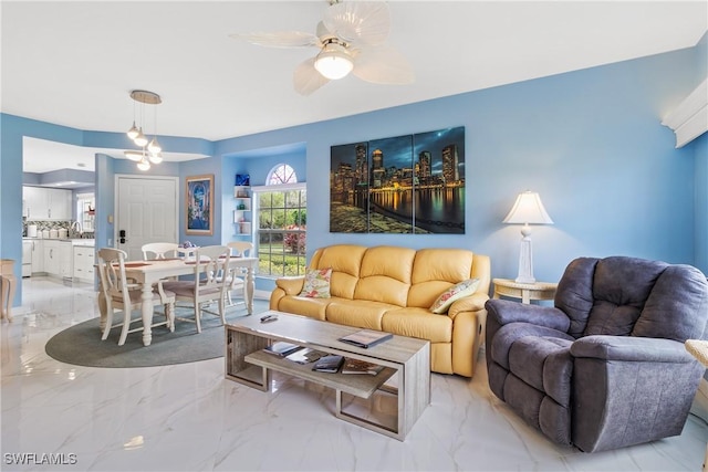 living room with ceiling fan and sink