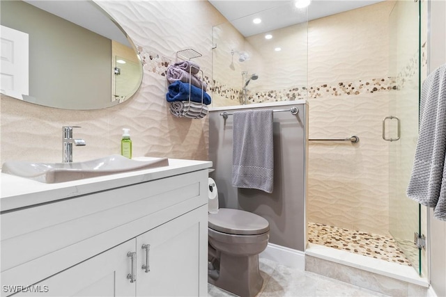 bathroom featuring vanity, toilet, decorative backsplash, and walk in shower