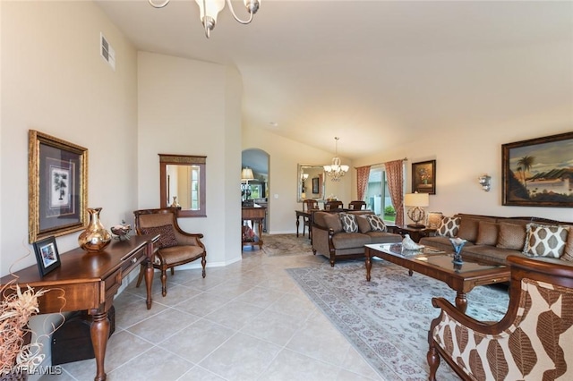 living room featuring light tile patterned floors, lofted ceiling, and an inviting chandelier