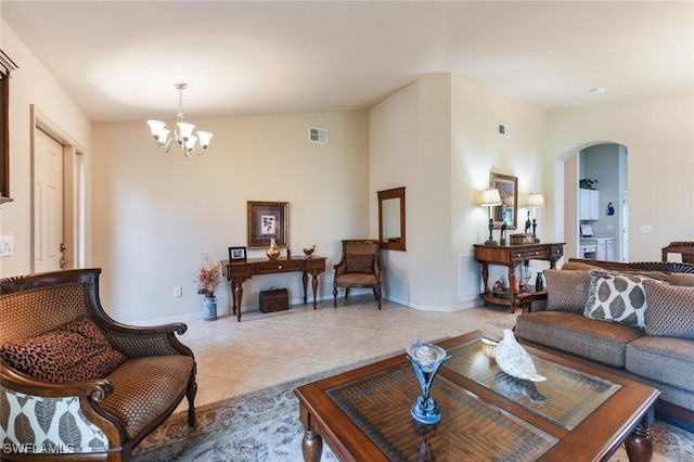 living room with an inviting chandelier and light tile patterned flooring