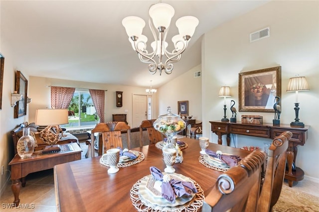 tiled dining space with lofted ceiling and a notable chandelier