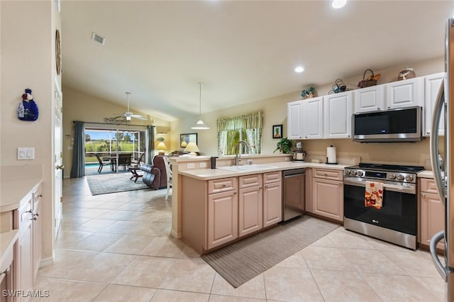 kitchen featuring appliances with stainless steel finishes, sink, hanging light fixtures, kitchen peninsula, and light tile patterned flooring