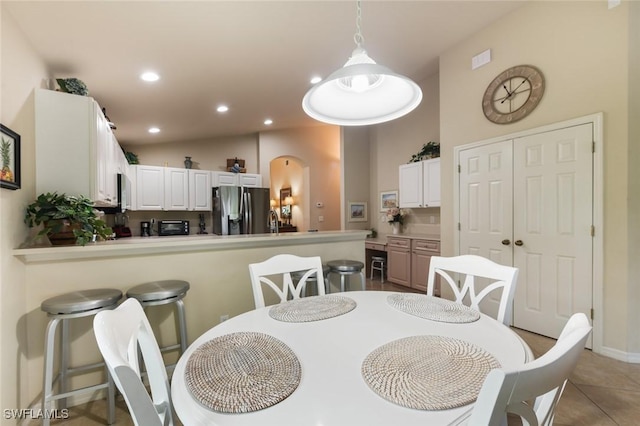 dining space featuring light tile patterned floors