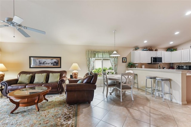 tiled living room with sink and ceiling fan