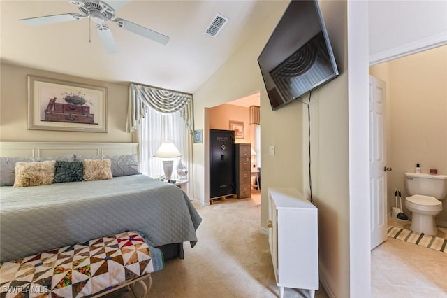 tiled bedroom with ceiling fan, connected bathroom, and lofted ceiling