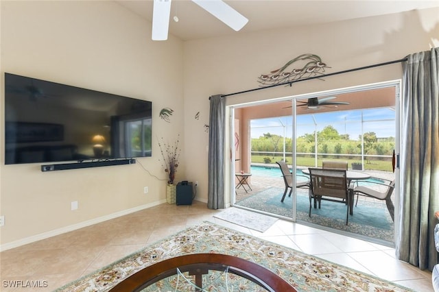 entryway with ceiling fan, light tile patterned floors, and lofted ceiling