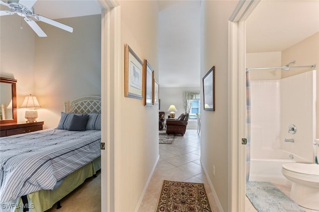 tiled bedroom featuring ceiling fan