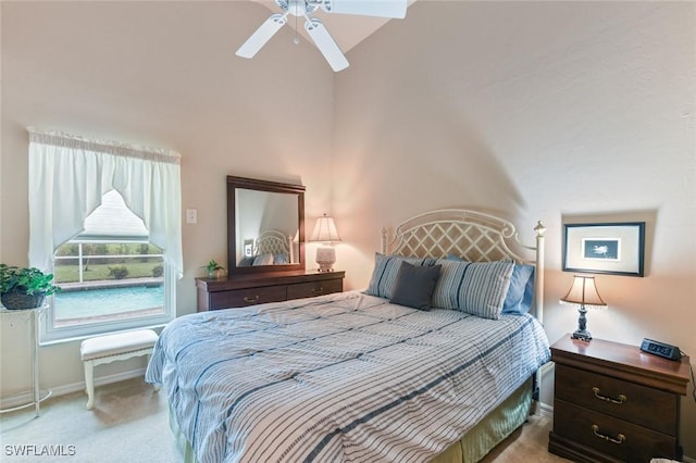 bedroom featuring ceiling fan, vaulted ceiling, and light carpet