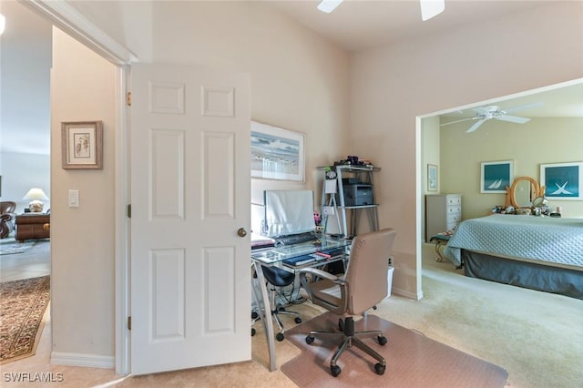 carpeted office space with ceiling fan and vaulted ceiling