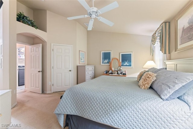 bedroom with light colored carpet, vaulted ceiling, and ceiling fan