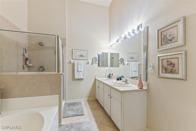 bathroom featuring independent shower and bath, vanity, and tile patterned flooring