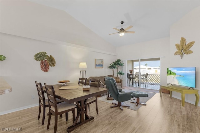 dining space featuring ceiling fan, light wood-type flooring, and high vaulted ceiling