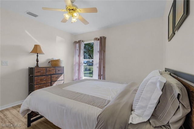 bedroom with ceiling fan and hardwood / wood-style flooring