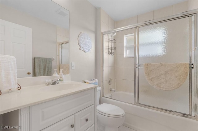 full bathroom with toilet, enclosed tub / shower combo, and vanity