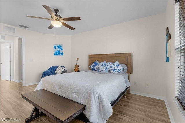 bedroom with ceiling fan and light wood-type flooring