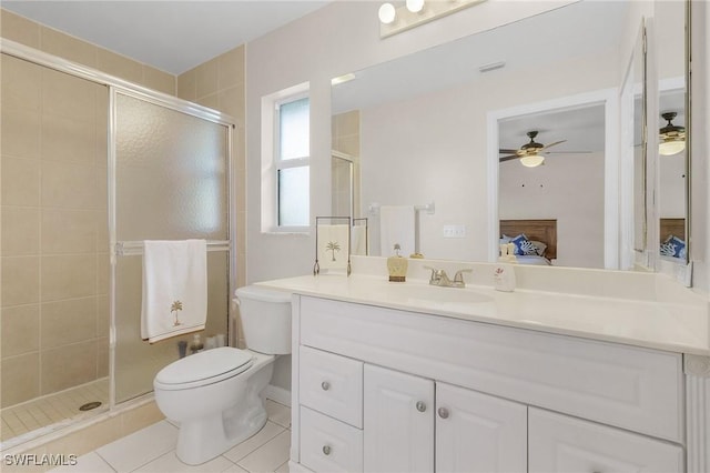 bathroom with tile patterned floors, vanity, toilet, walk in shower, and ceiling fan