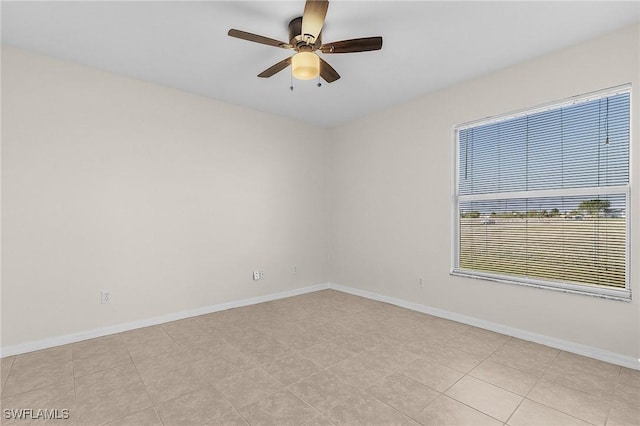 unfurnished room featuring ceiling fan and light tile patterned flooring