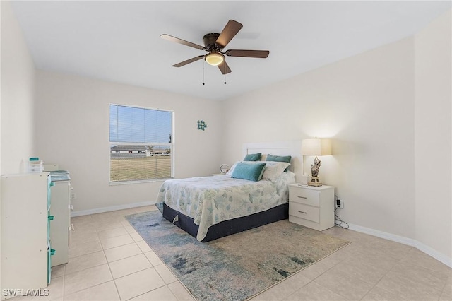 tiled bedroom featuring ceiling fan