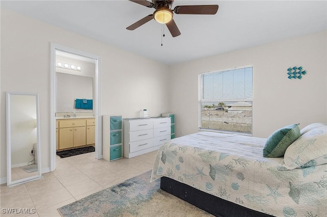 bedroom with light tile patterned flooring, ceiling fan, and ensuite bathroom