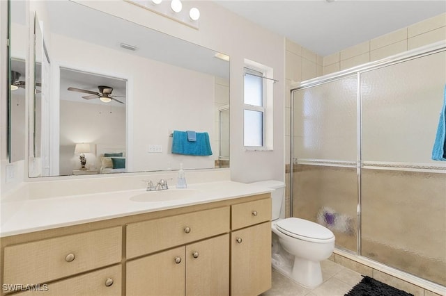 bathroom with toilet, ceiling fan, tile patterned floors, walk in shower, and vanity