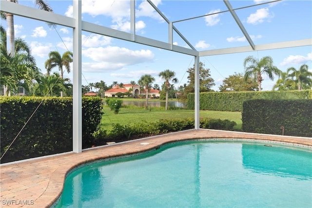 view of pool featuring a water view, a yard, a lanai, and a patio area