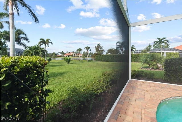 view of yard featuring a water view and a patio