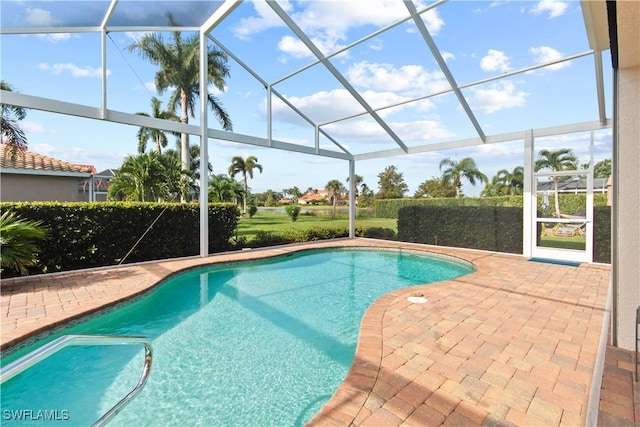 view of swimming pool with a lanai and a patio area