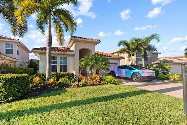 mediterranean / spanish house featuring a garage and a front lawn