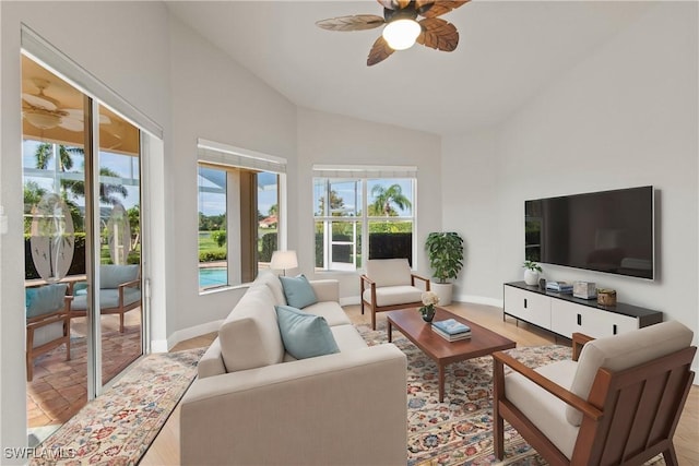 living room with ceiling fan and lofted ceiling