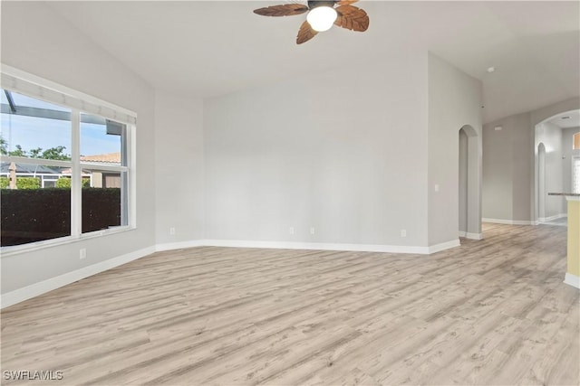 spare room with lofted ceiling, ceiling fan, and light hardwood / wood-style flooring