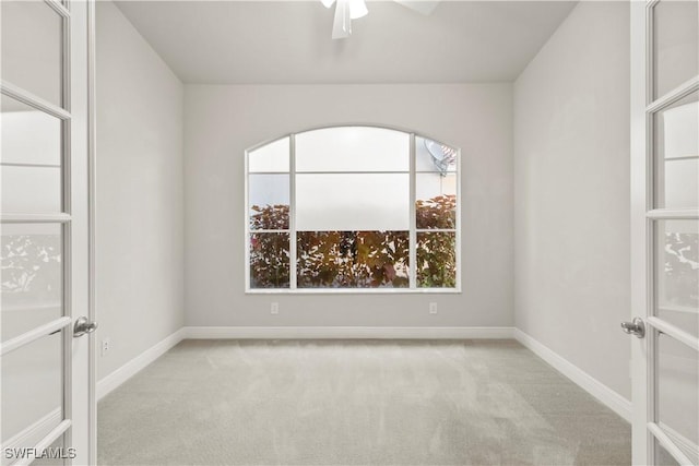 carpeted empty room with ceiling fan