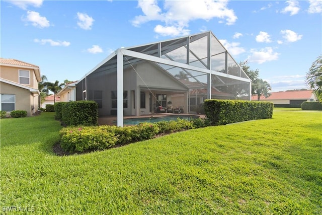 rear view of property featuring a yard and glass enclosure