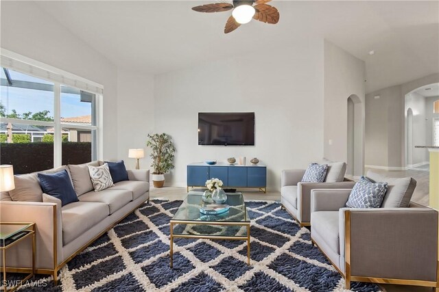 living room with ceiling fan and vaulted ceiling