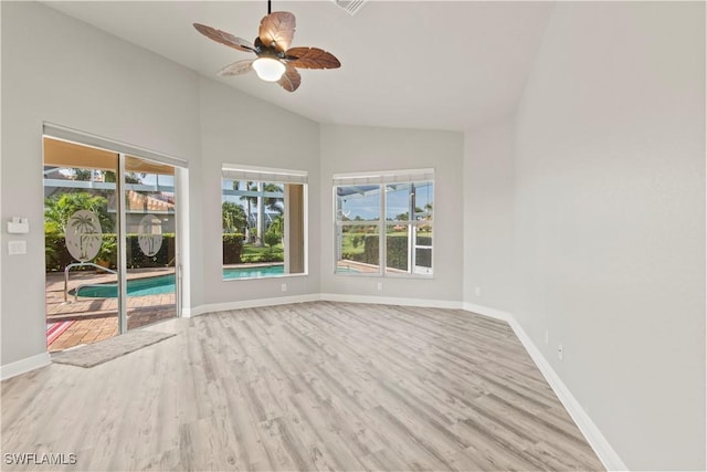 empty room with vaulted ceiling, light wood-type flooring, and ceiling fan