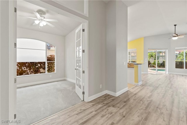 interior space featuring lofted ceiling and light hardwood / wood-style flooring